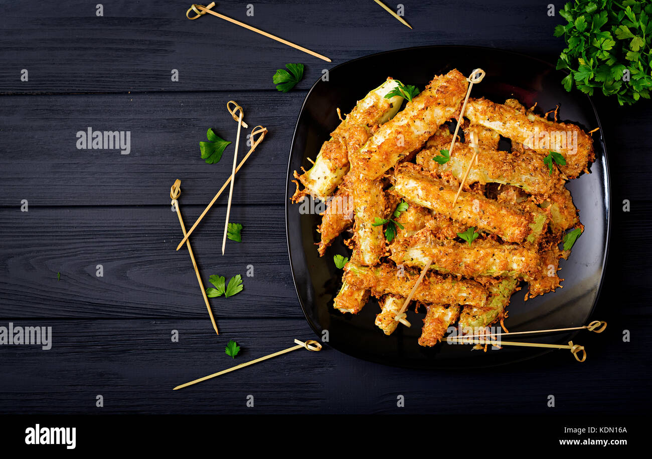 Zucchini slices baked under cheese breading Stock Photo