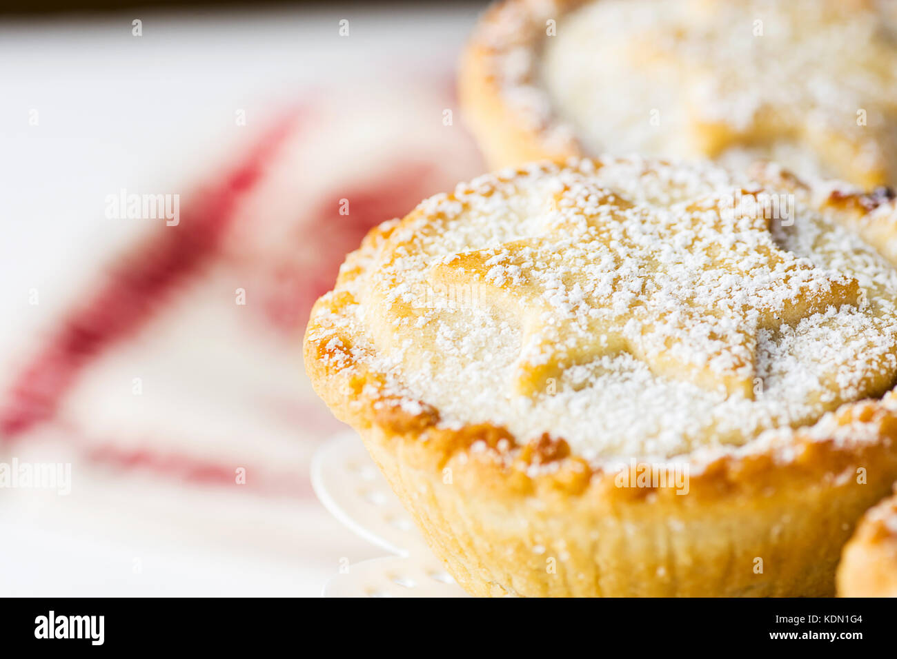 Traditional British Christmas Pastry Dessert Home Baked Mince Pies with Apple Raisins Nuts Filling on White Elegant Cake Stand. Golden Shortcrust Powd Stock Photo