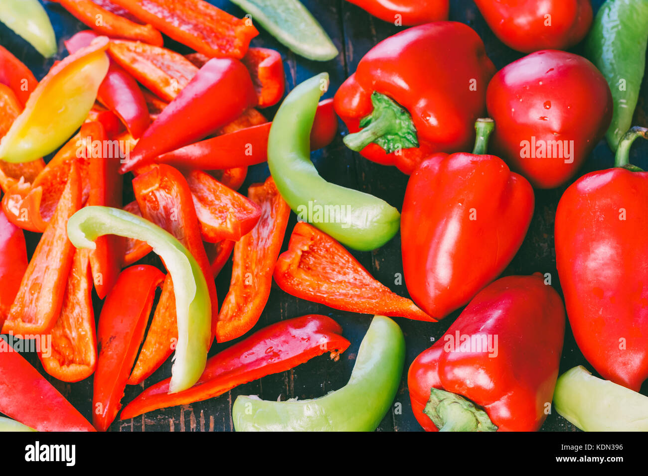 whole and sliced red and green bell peppers closeup Stock Photo - Alamy