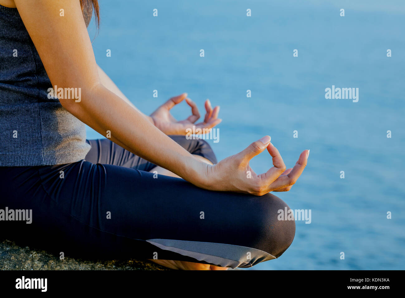 The woman meditating in a yoga pose on the tropical beach. Female ...