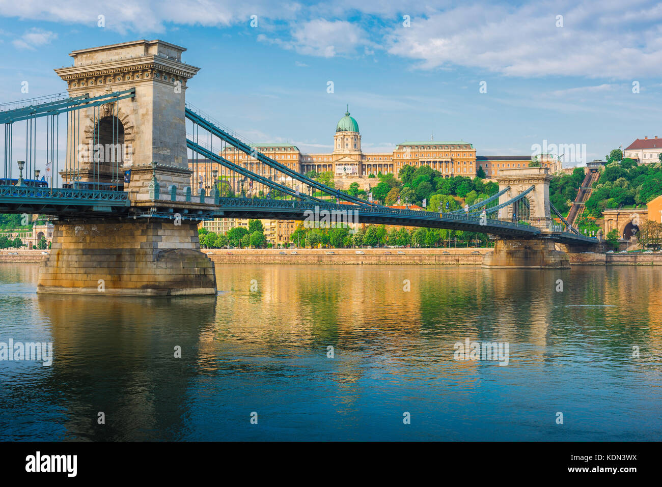 Budapest bridge Danube, view of the Lanchid Bridge spanning the Danube River with the Royal Palace in the background, Budapest, Hungary Stock Photo