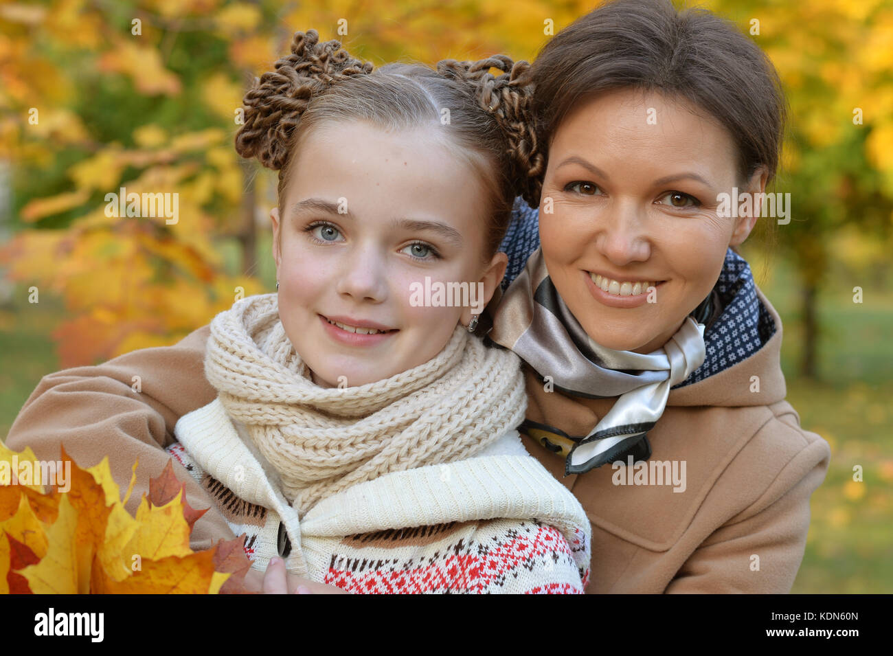 Portrait of happy mother and daughter in autumn park Stock Photo - Alamy