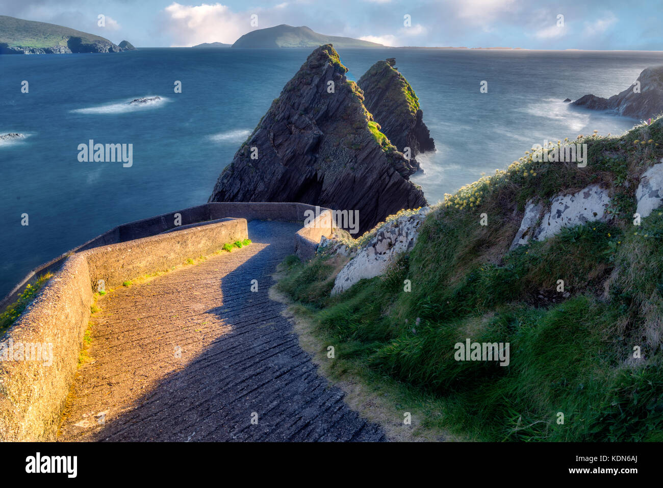 Road to Dunquin Pier with offshore rocks and winding road. County Kerry, Ireland Stock Photo