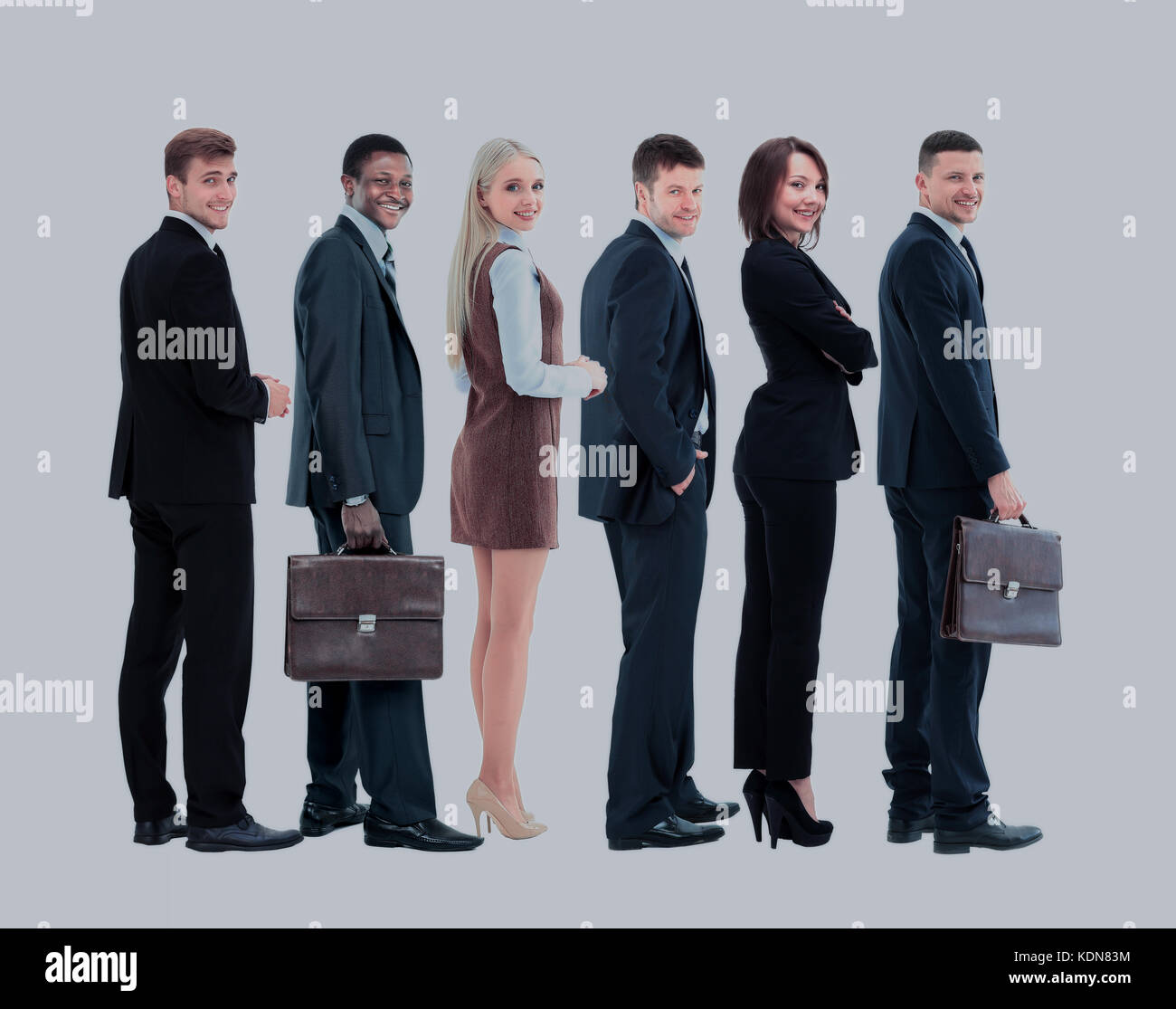 Happy smiling young business people staying. Side view Stock Photo - Alamy