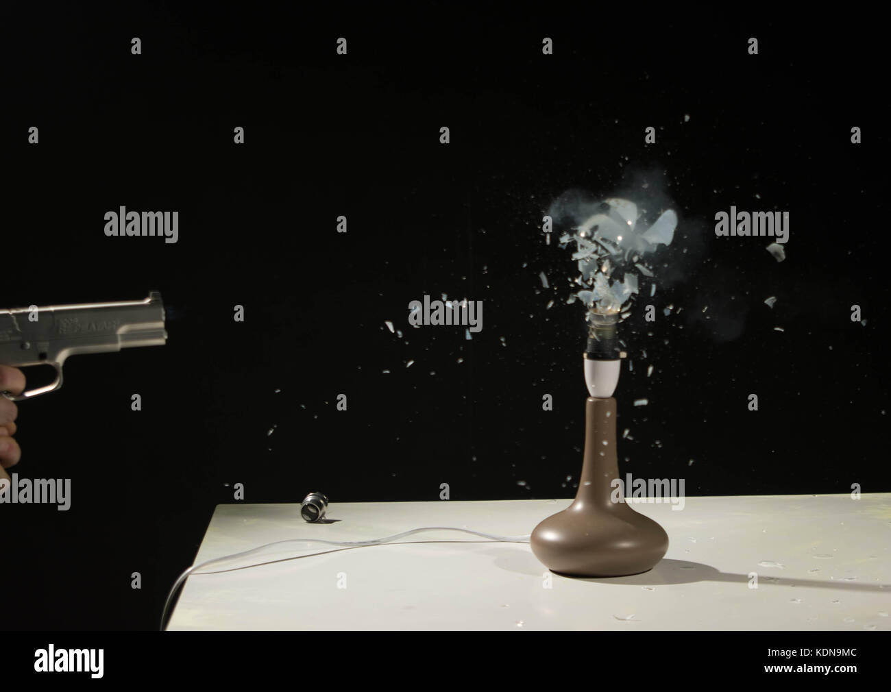 Pellet hitting Exploding lightbulb Stock Photo Alamy