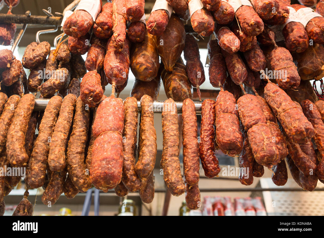 Salami, pepperoni and assorted cured dried meats hanging in Italian