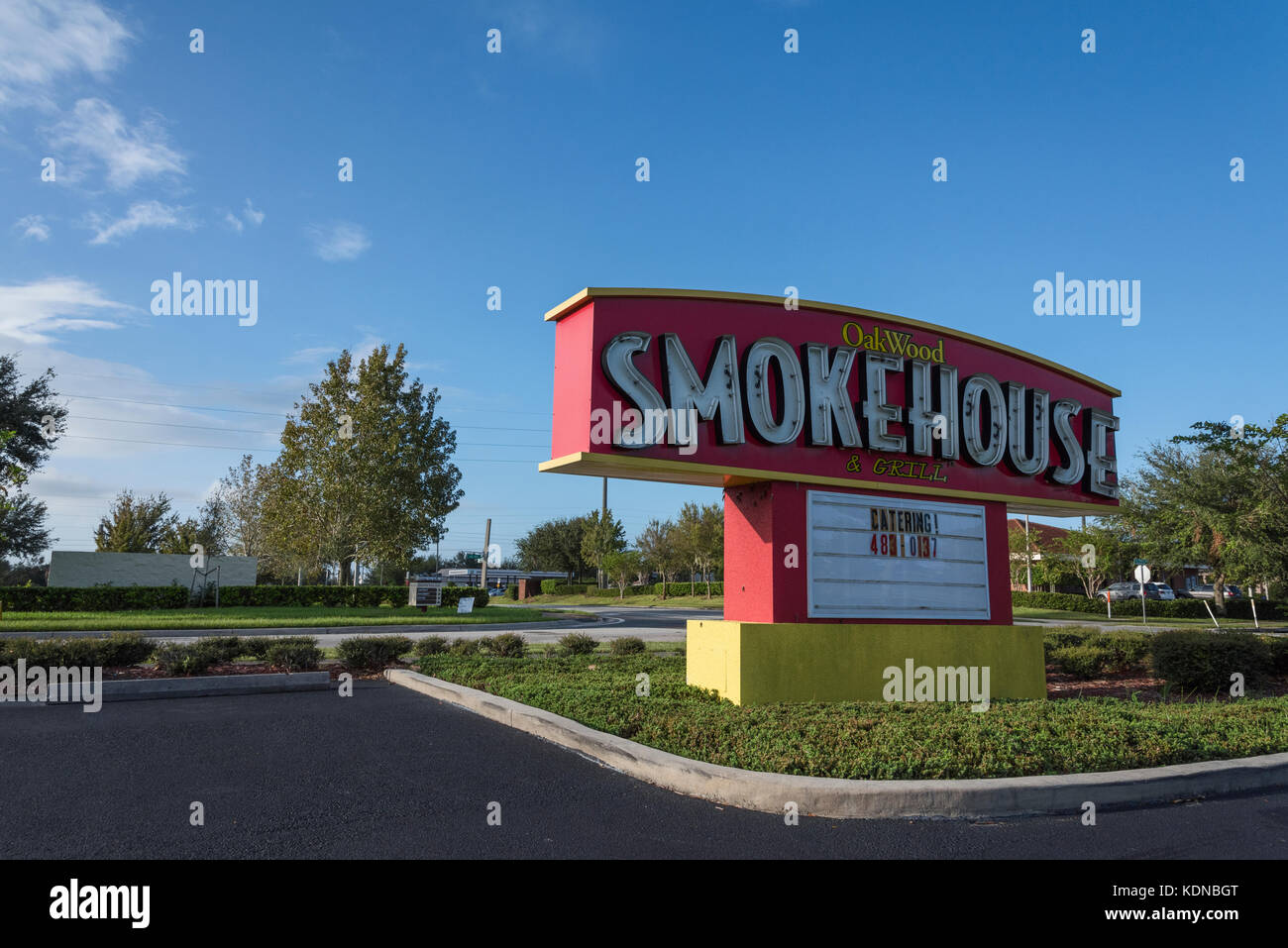 Oakwood Smokehouse Storefront Sign Post located in Eustis, Florida USA