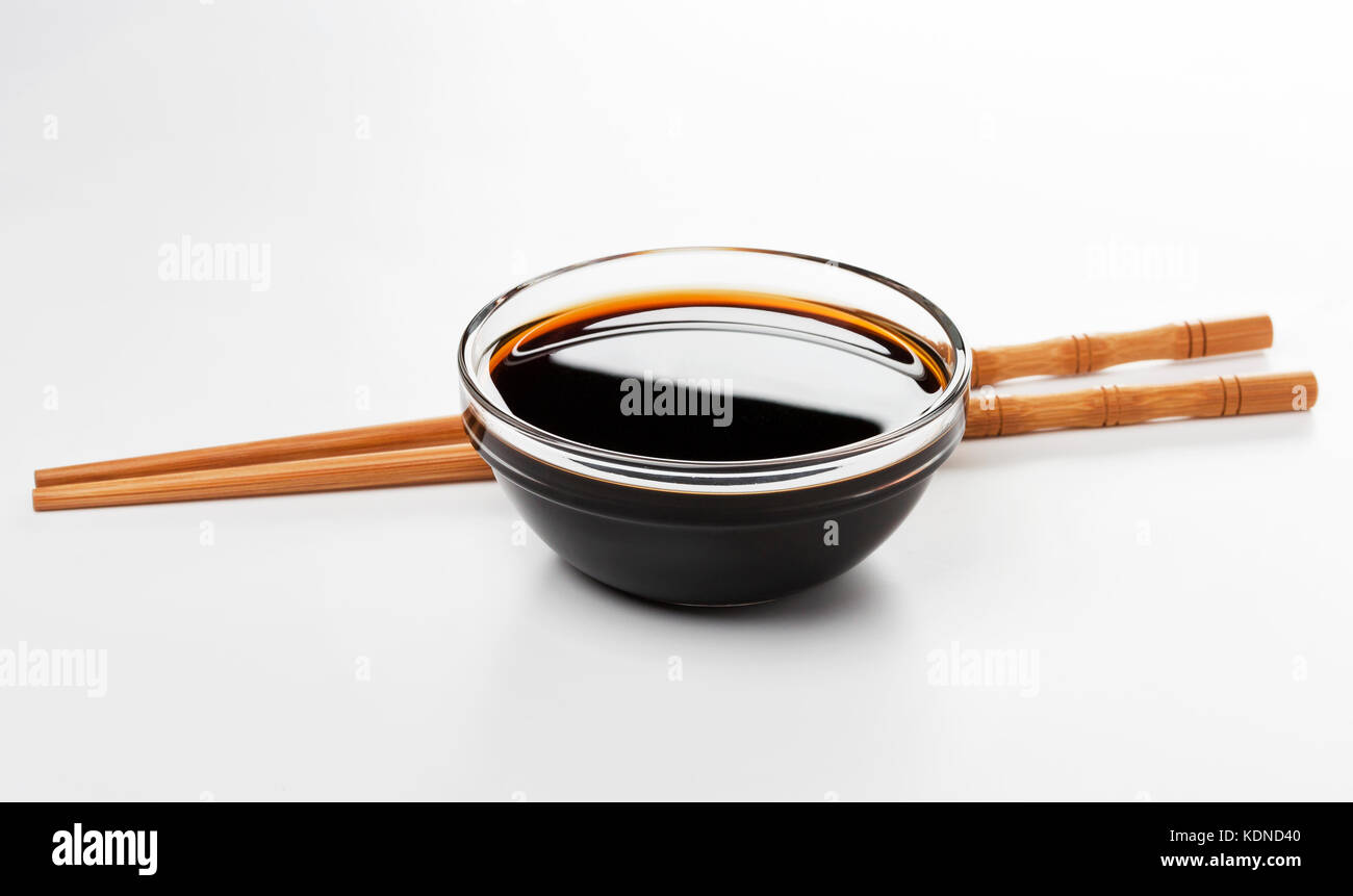Soy sauce and chopsticks isolated on white background Stock Photo