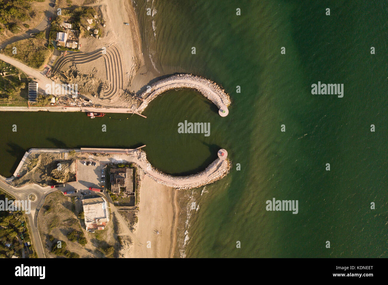 Aerial view of an entrance to the port on Sabaudia beach at sunset. Stock Photo