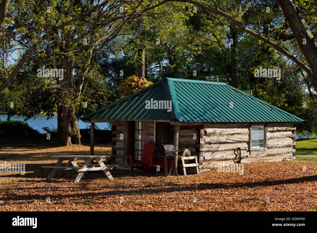 Rustic log cabin in the Fall on Lake on the Mountain Provincial Park with sinkhole lake Prince Edward County Ontario Canada Stock Photo