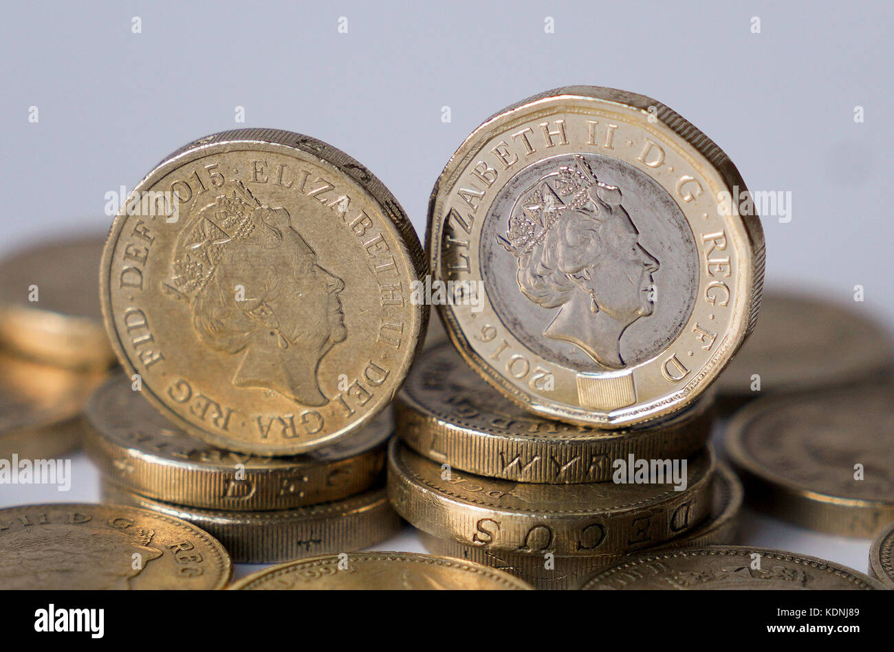 Examples of the old £1 coin (left) and the new one replacing it, as from midnight on Sunday the round pound will no longer be legal tender and businesses are no longer obliged to accept them. Stock Photo