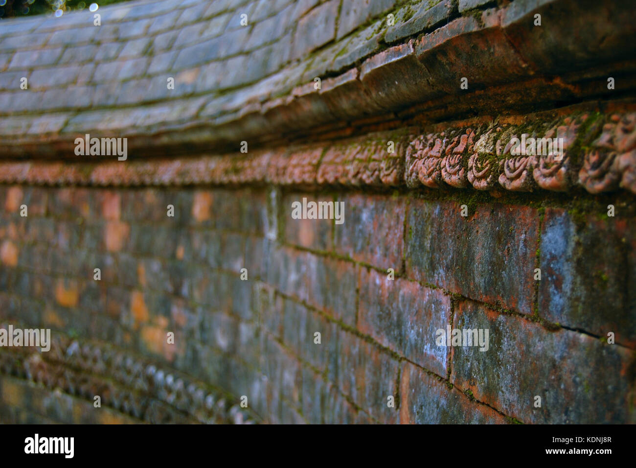 Entryway Wall Decor. Selective focus. Hindu temple. Old bricks texture. Vajrayogini Temple near Kathmandu, Nepal. Stock Photo