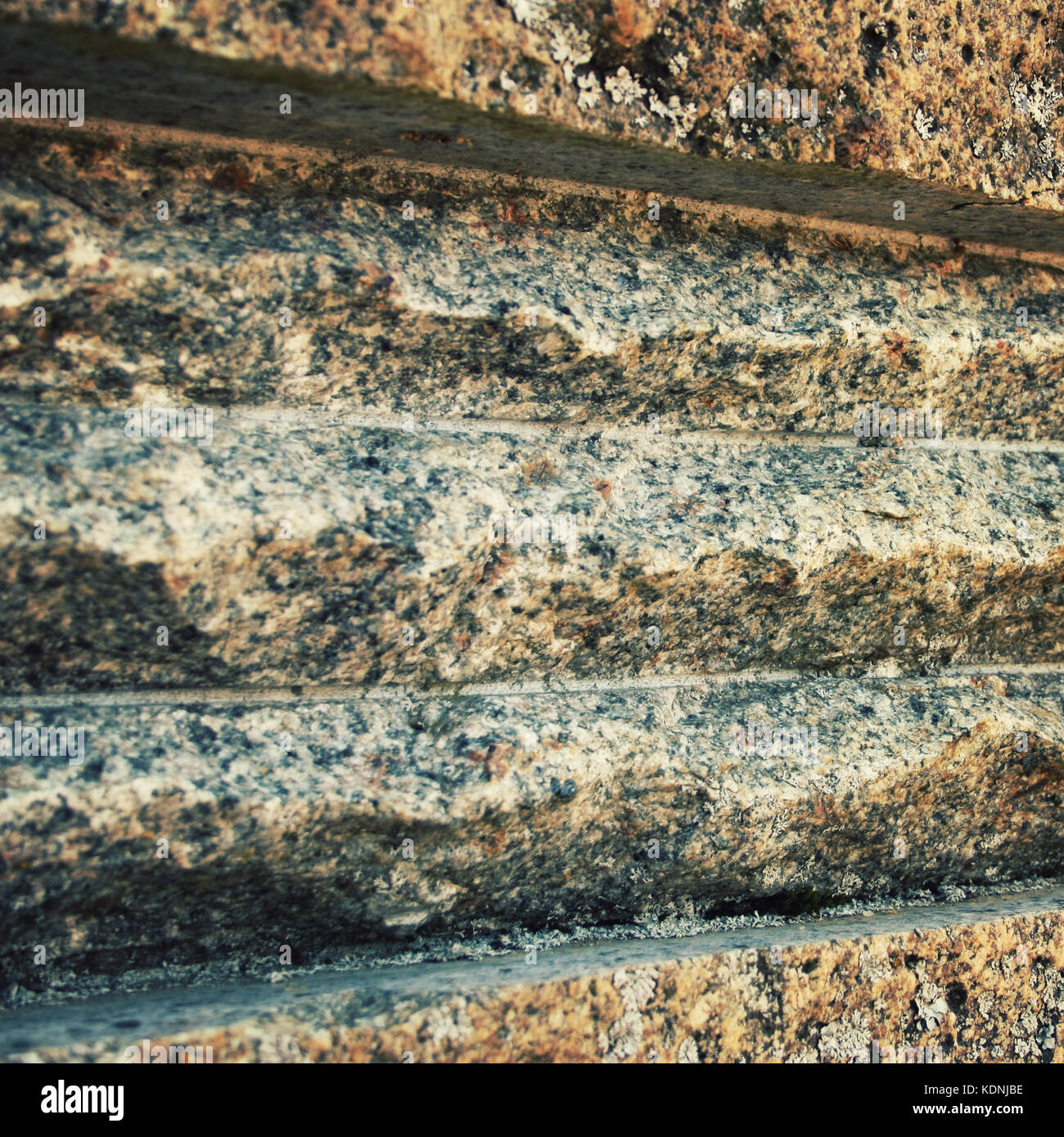 Carved grooves on the stone surface. Close up. Rough rock texture. Toned photo. Stock Photo