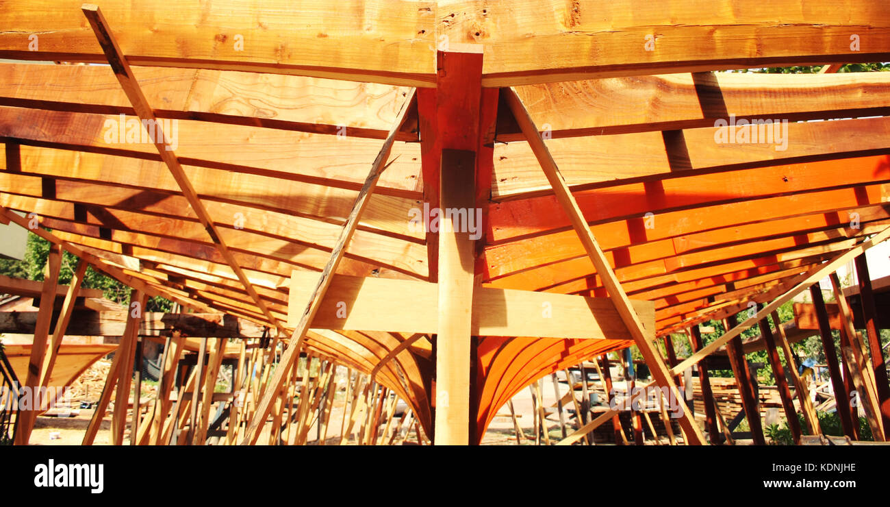 Building a boat. Under construction. Toned photo. The wooden keel beams. Orange wood. Colorful image. Traditional methods. Turkey. Stock Photo