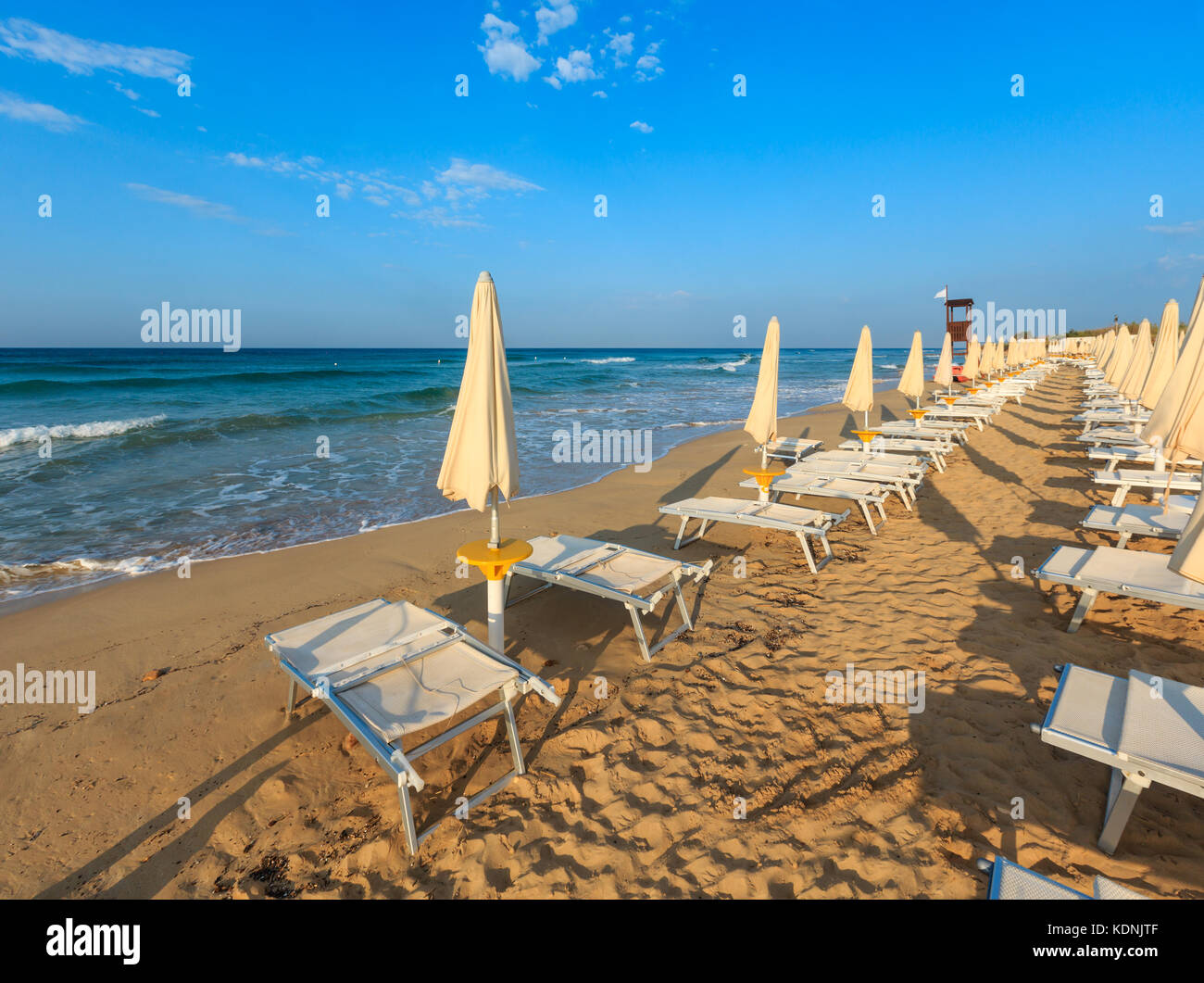 Morning paradise white sandy beach The Maldives of Salento with sunshades and sunbeds (Pescoluse, Salento, Puglia, south Italy). The most beautiful se Stock Photo