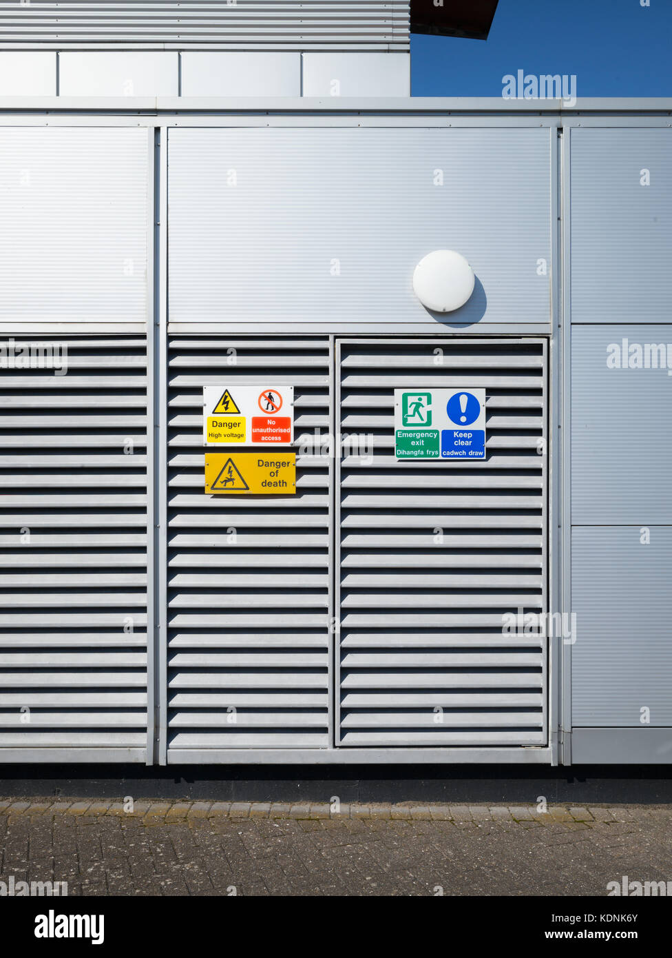 Safety And Warning Signs Fixed To Louvres Of Metal Door Cardiff Bay Cardiff Uk Stock Photo Alamy