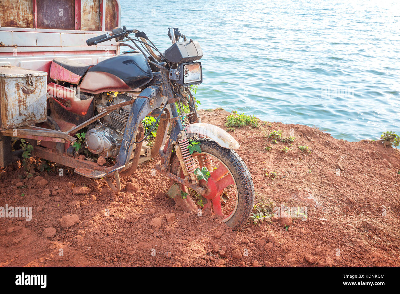 Broken motorcycle beside the sea Stock Photo Alamy
