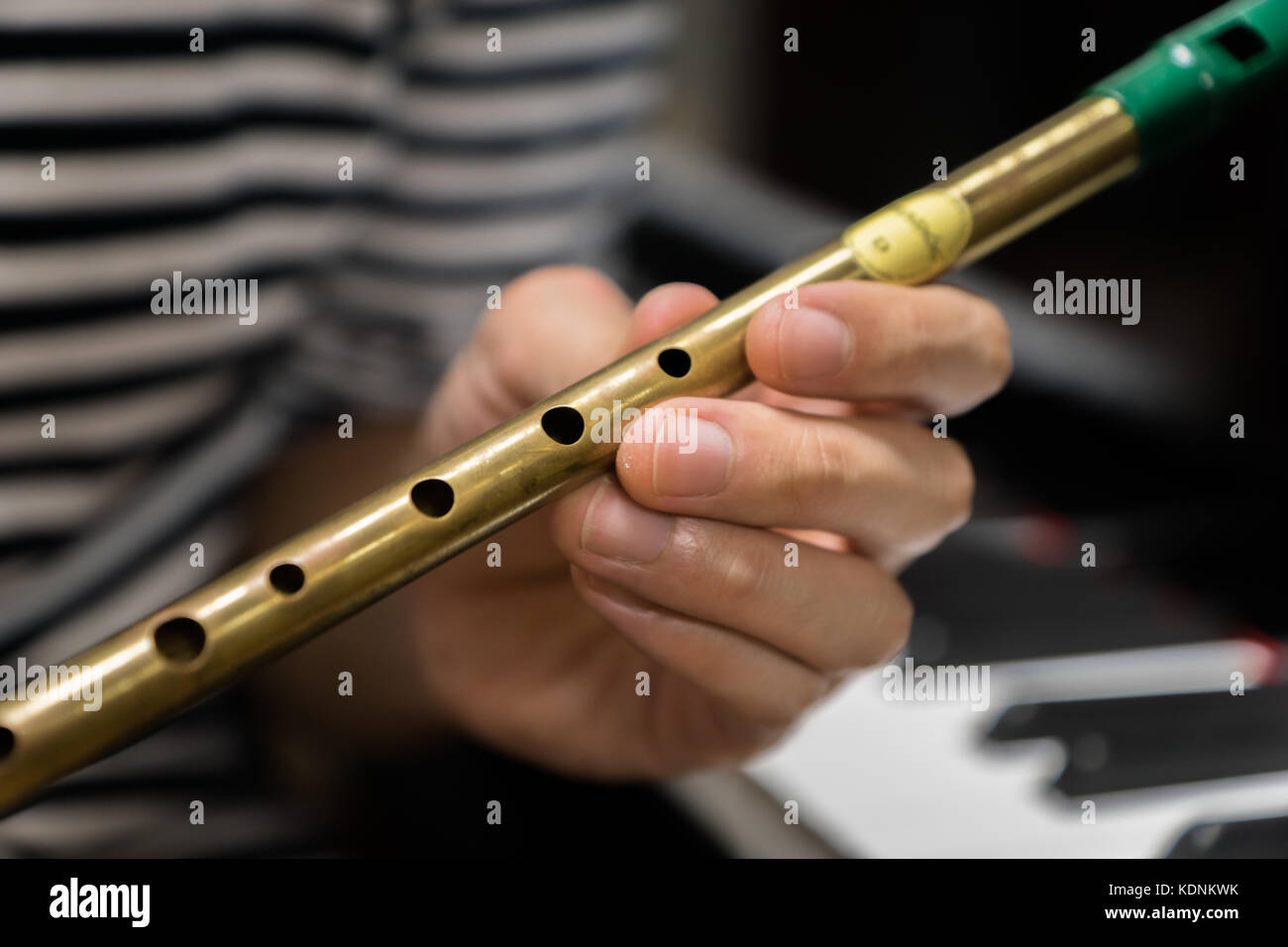 Irish tin whistle for celtic folk music in front of piano Stock Photo