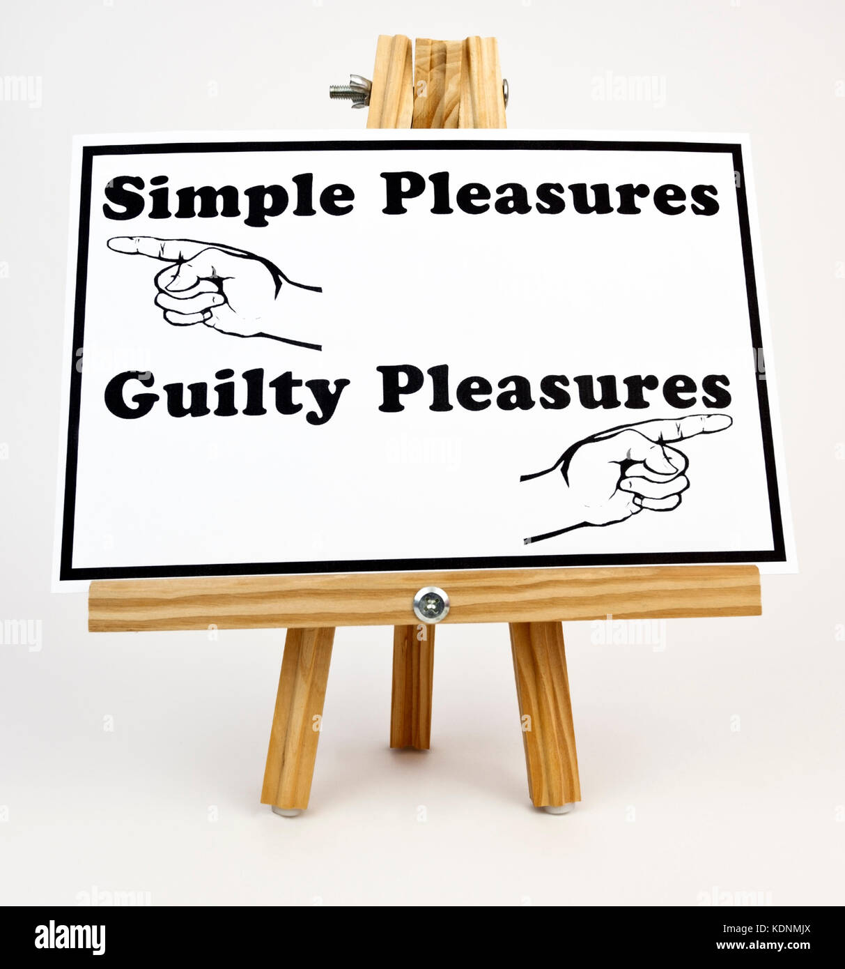 PLEASURES sign on easel. SIMPLE PLEASURES to the left. GUILTY PLEASURES to the right. Stock Photo