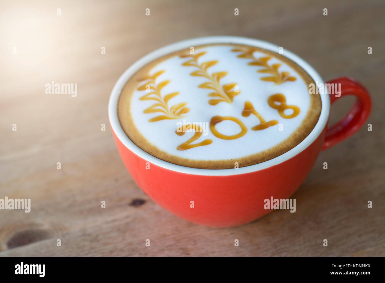 hot coffee with foam milk art 2018 on wooden table, latte art coffee Stock Photo