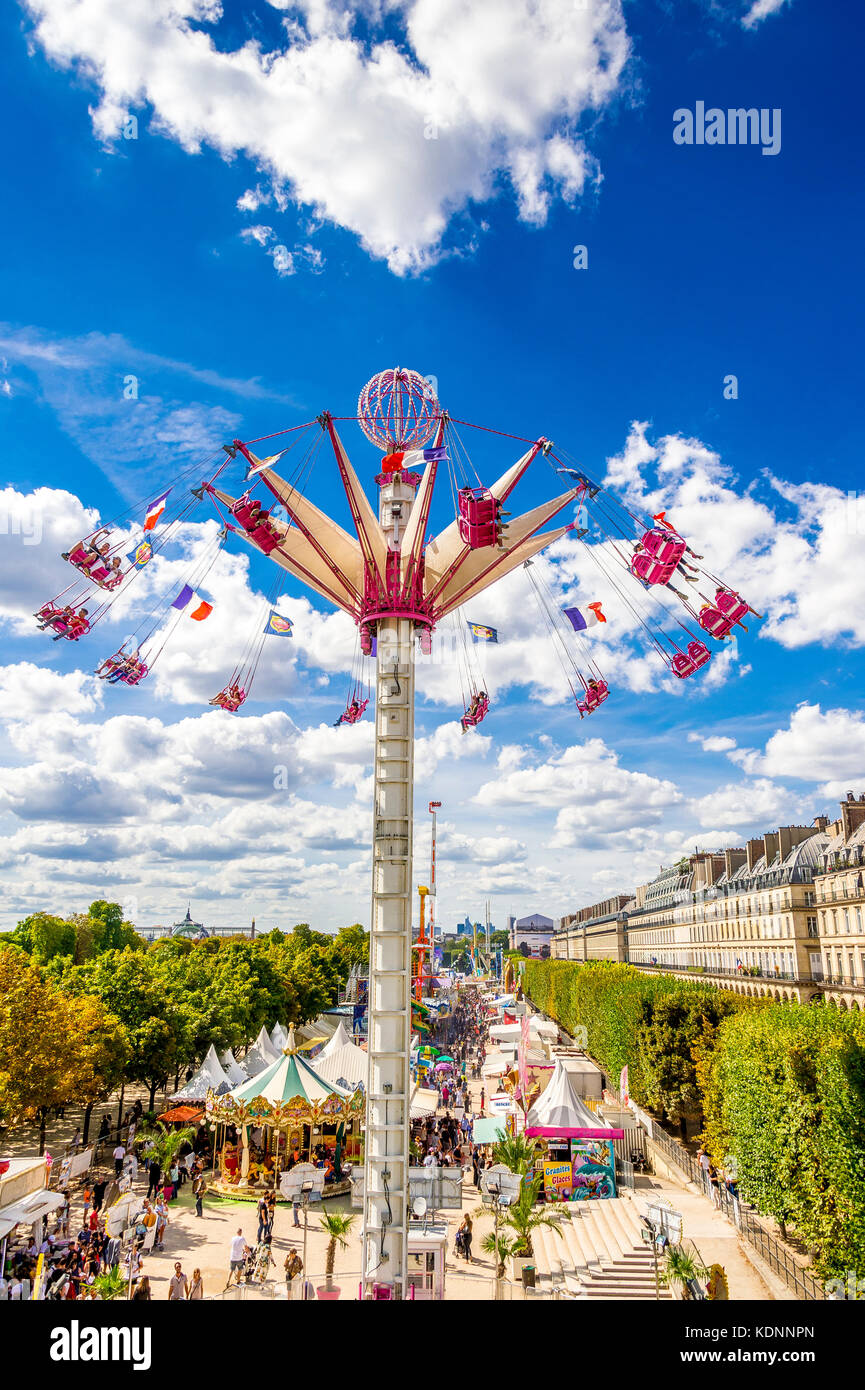 The swinging chairs within the Fete des Tuileries in Paris Stock Photo