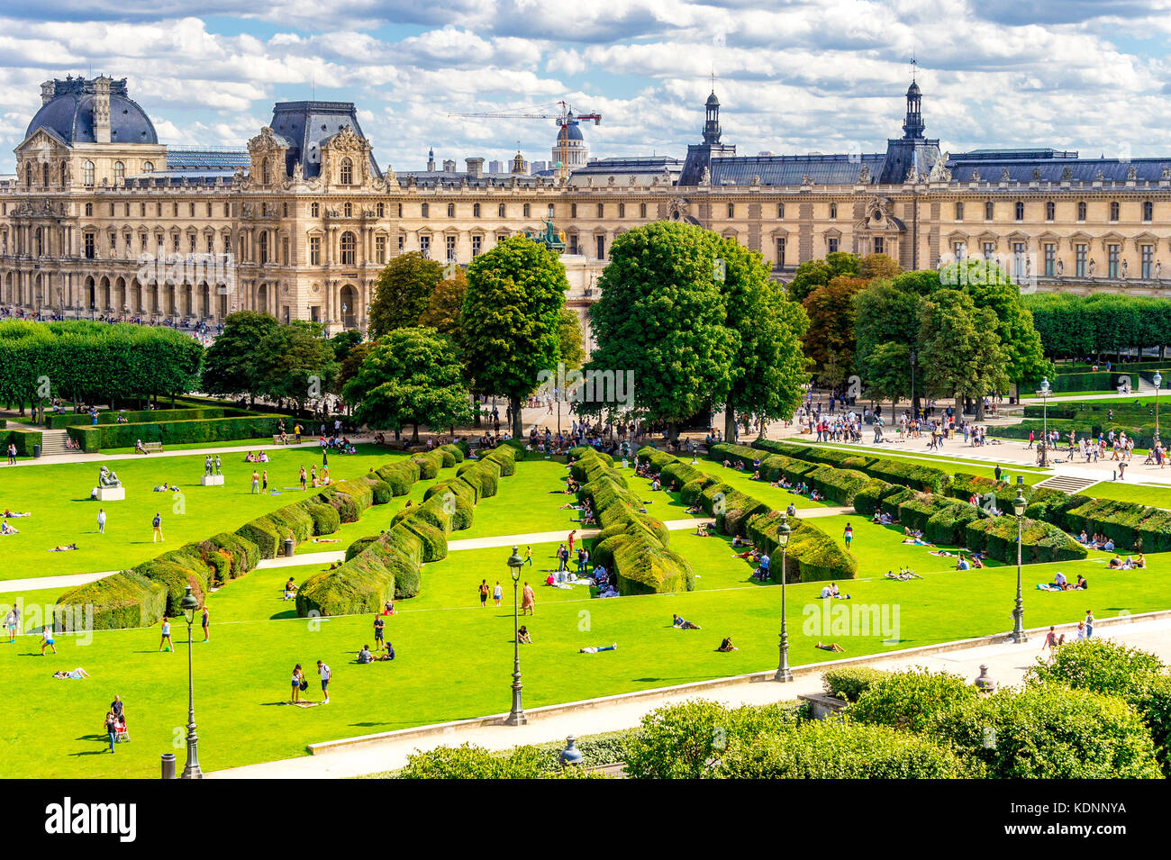 the Jardin Tuileries (Tuileries Garden), and the beautiful architecture of the Louvre is on display in the background. Paris, France Stock Photo