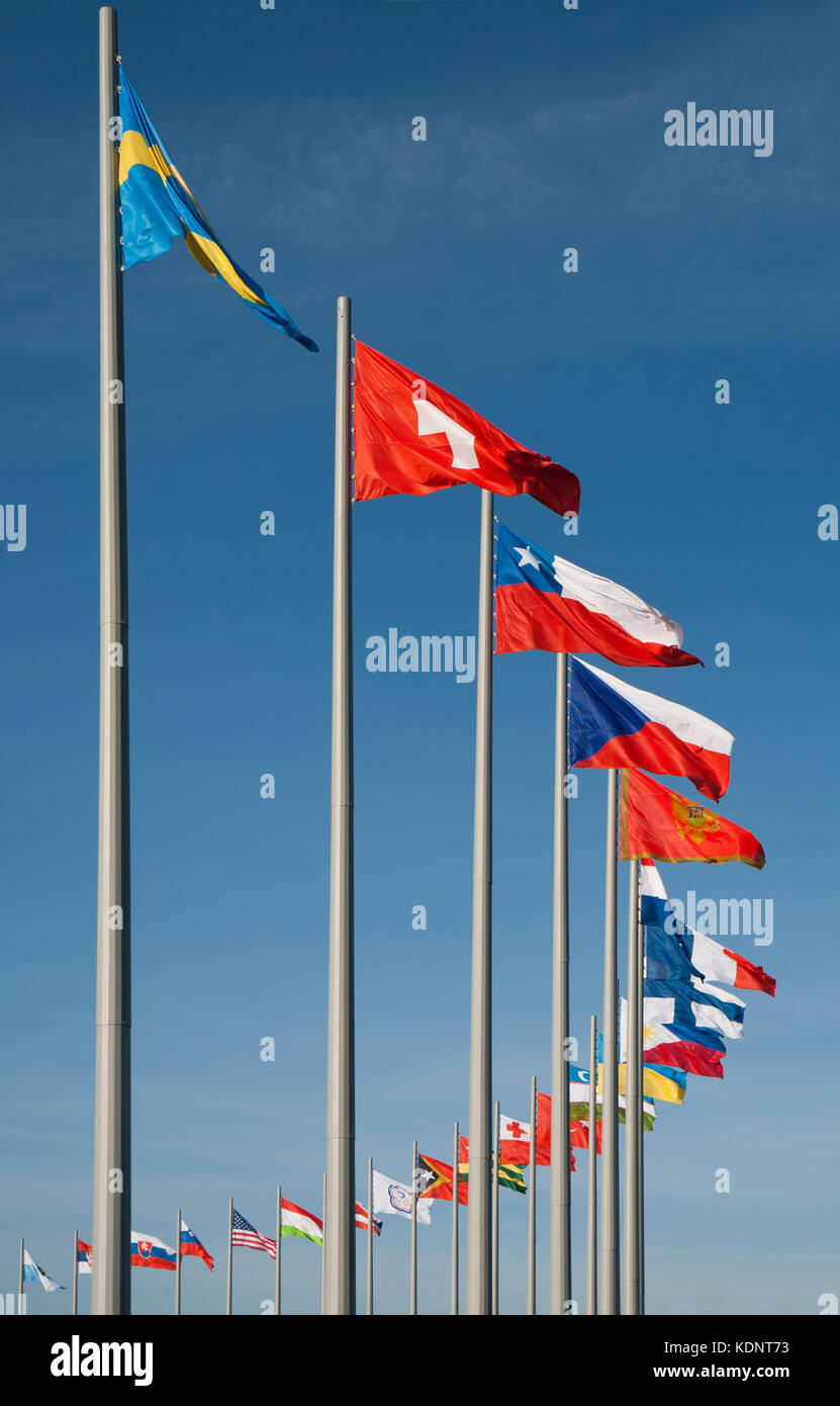 Flags of different countries against the background of blue sky Stock Photo