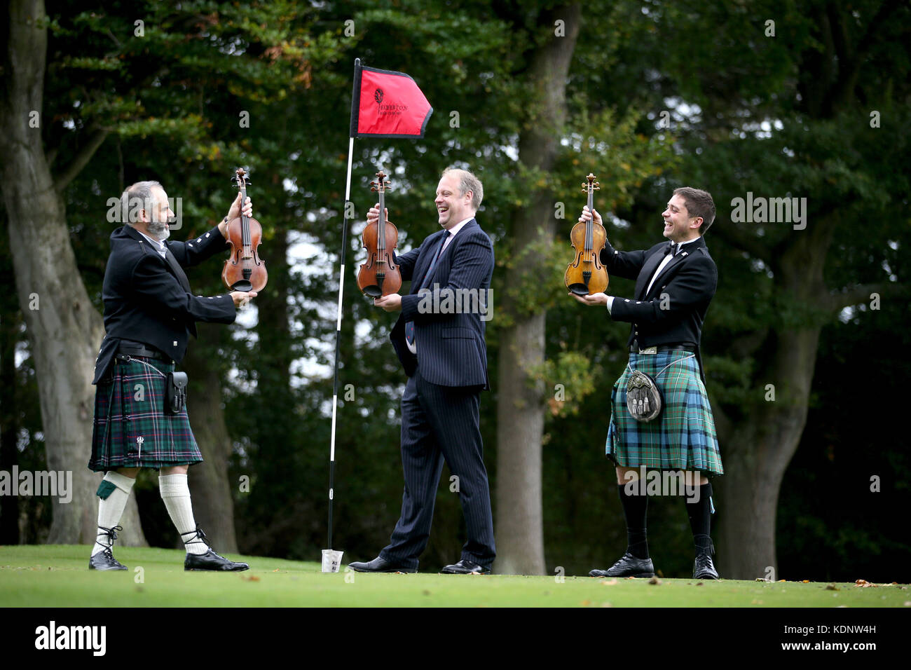 (left to right) Violin-maker Steve Burnett holding the Siegfried Sassoon violin, historian Neil McLennan, holding the Robert Graves violin and fiddle player Thoren Ferguson holding the Wilfred Owen violin, at Baberton Golf Club in Edinburgh. The three violins, made in commemoration of the war poets who met at the golf club in 1917, are to be played together for the first time. Stock Photo