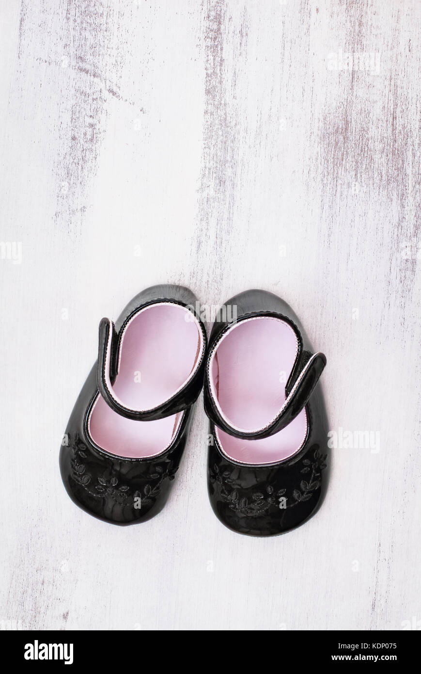 Baby girl black patent shoes shot from above. Stock Photo