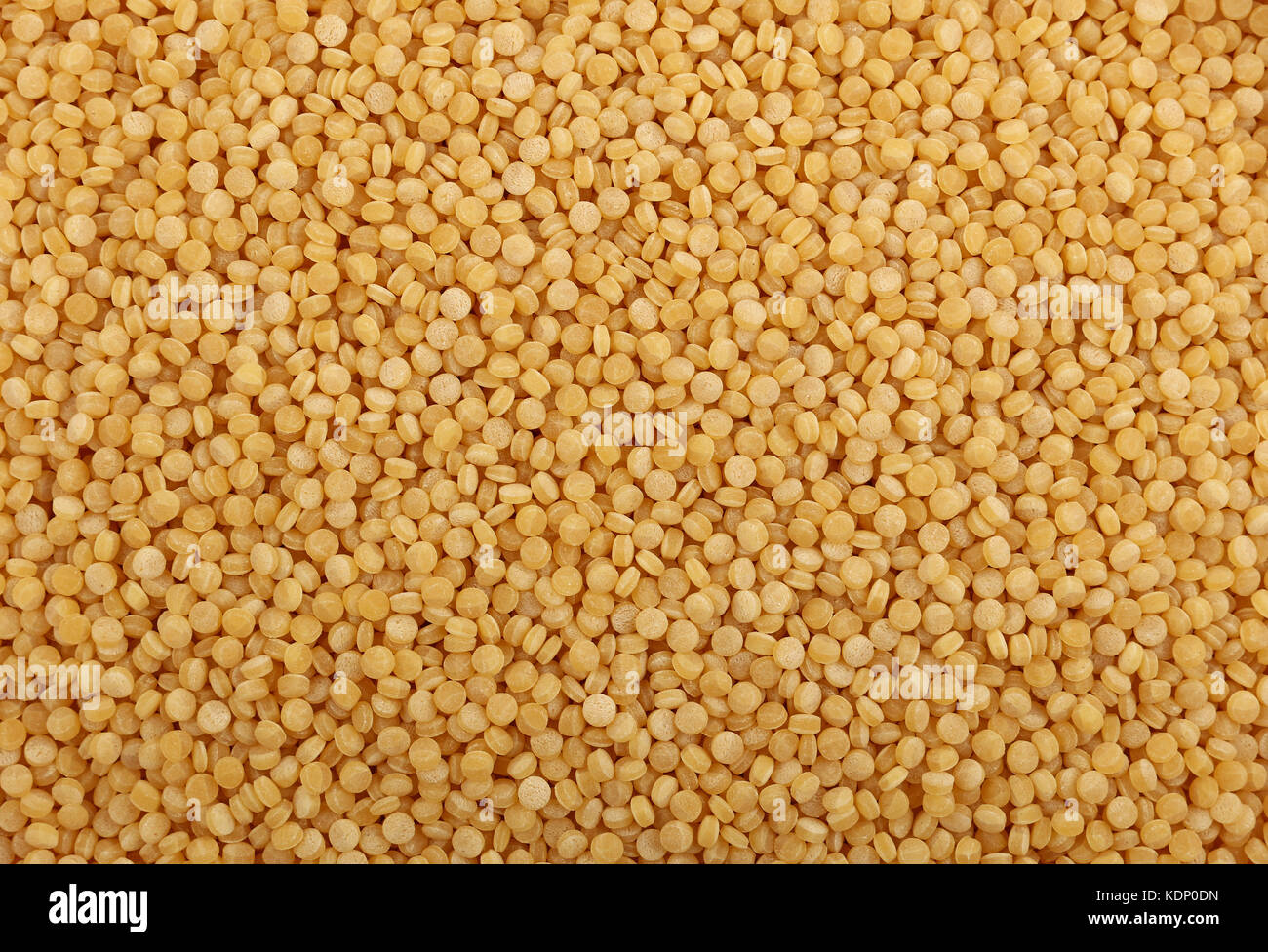 Traditional ptitim pasta (Israeli or pearl couscous) close up pattern background, elevated top view Stock Photo