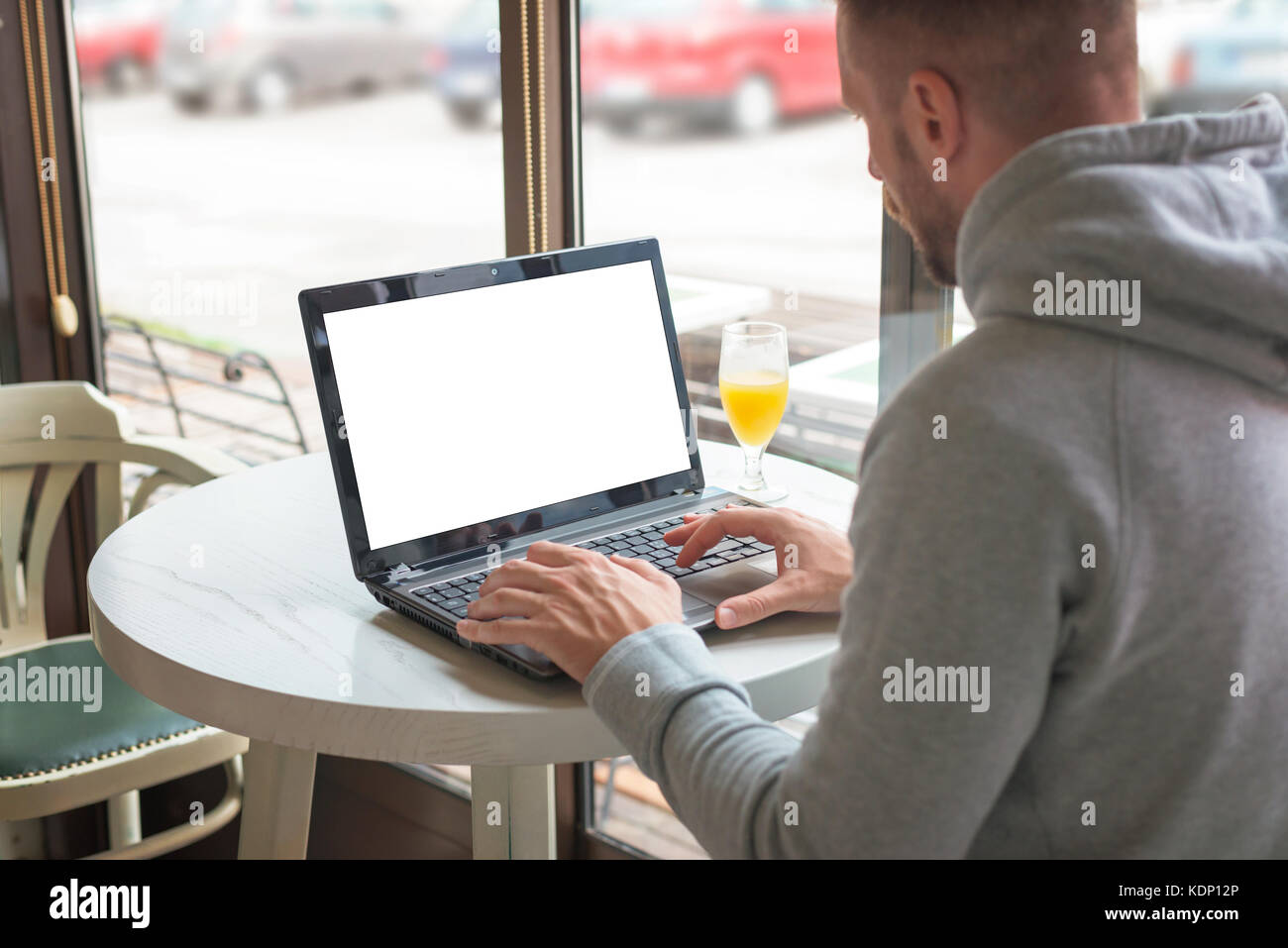 Man work on laptop in coffee shop. Isolated screen for app or web site mockup promotion. Stock Photo