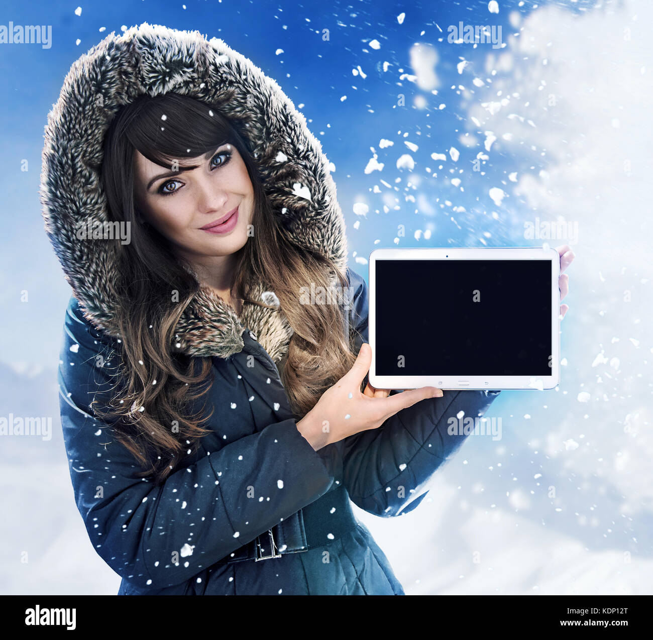 Brunette Woman Presenting A Tablet Outside Winter Chill Day Stock 