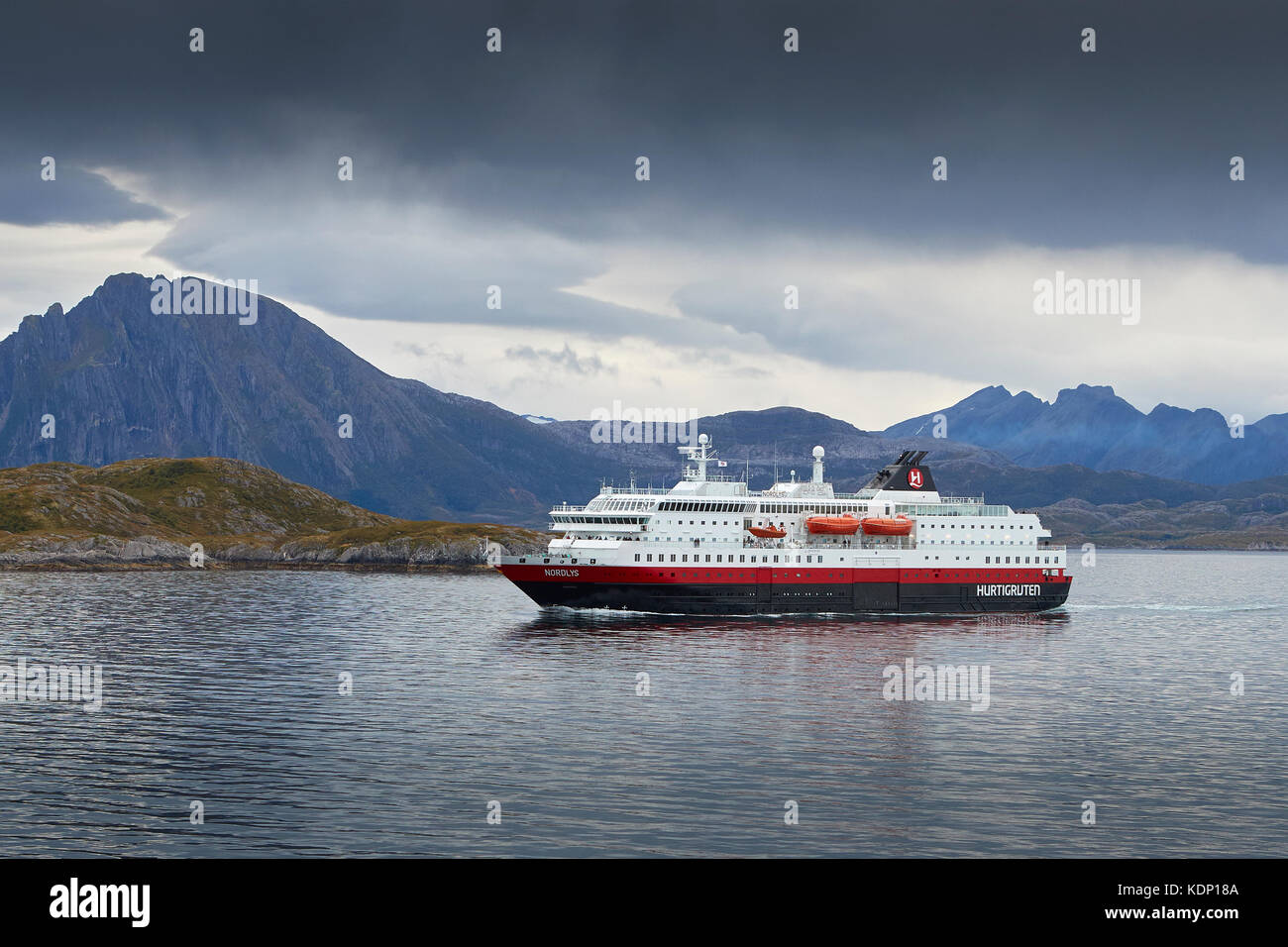 Hurtigruten Passenger Ferry, MS Nordlys, Sailing North Through The Rødøyfjorden, A Short Distance To The North Of The Norwegian Arctic Circle. Stock Photo