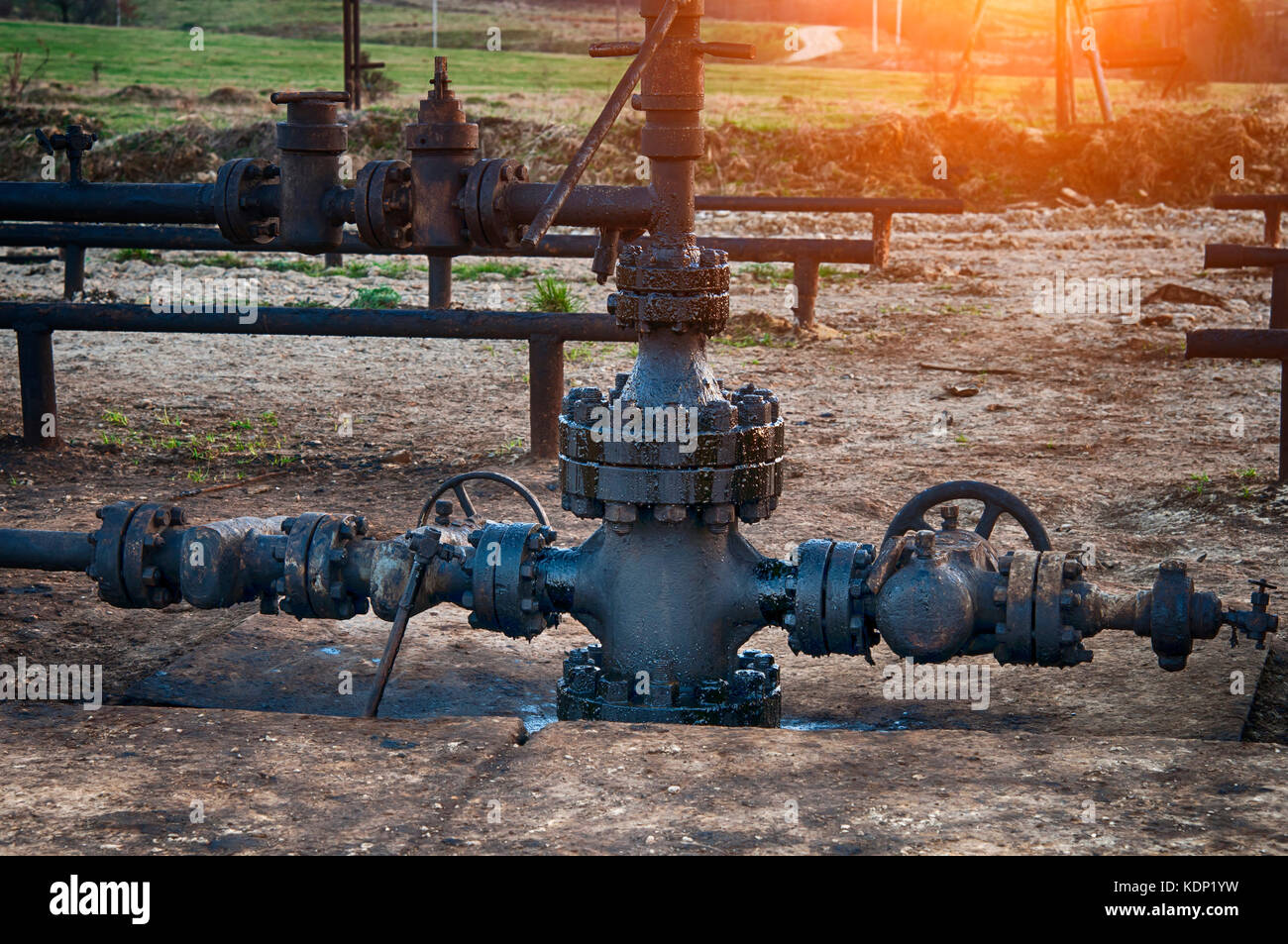 Spilled crude oil around oil field. Oil and Gas Industry Stock Photo