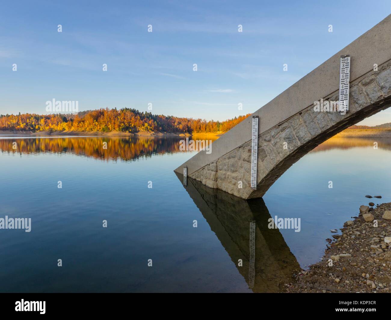 Autumn on lake near dam serene serenity peaceful water surface vivid color on trees forest reflection reflections Stock Photo