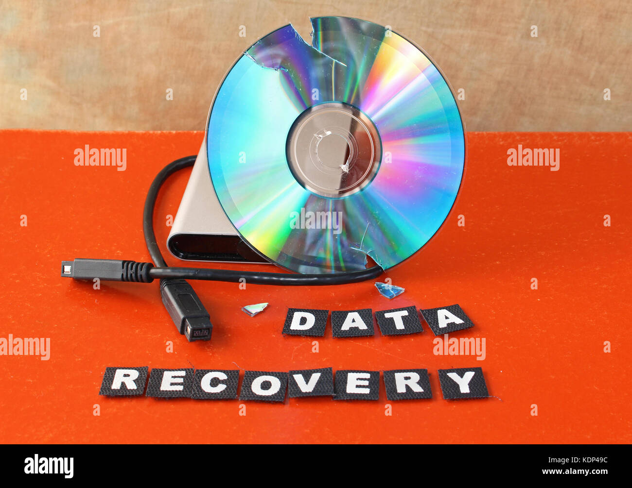 Broken DVD disc with data recovery text Stock Photo