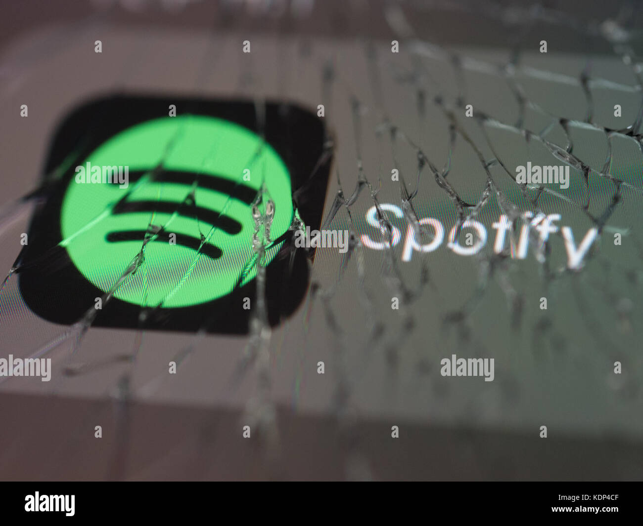 Spotify logo displayed on a broken smartphone screen Stock Photo