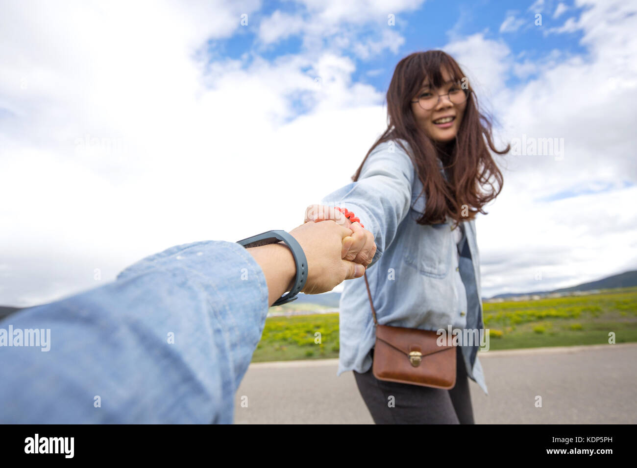 Asian girl pulling hand Stock Photo Alamy