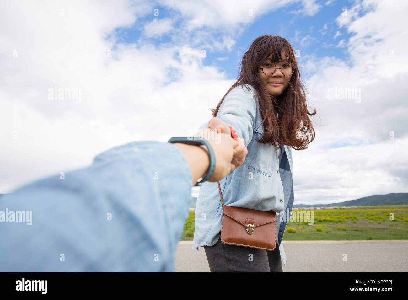 Asian girl pulling hand Stock Photo Alamy
