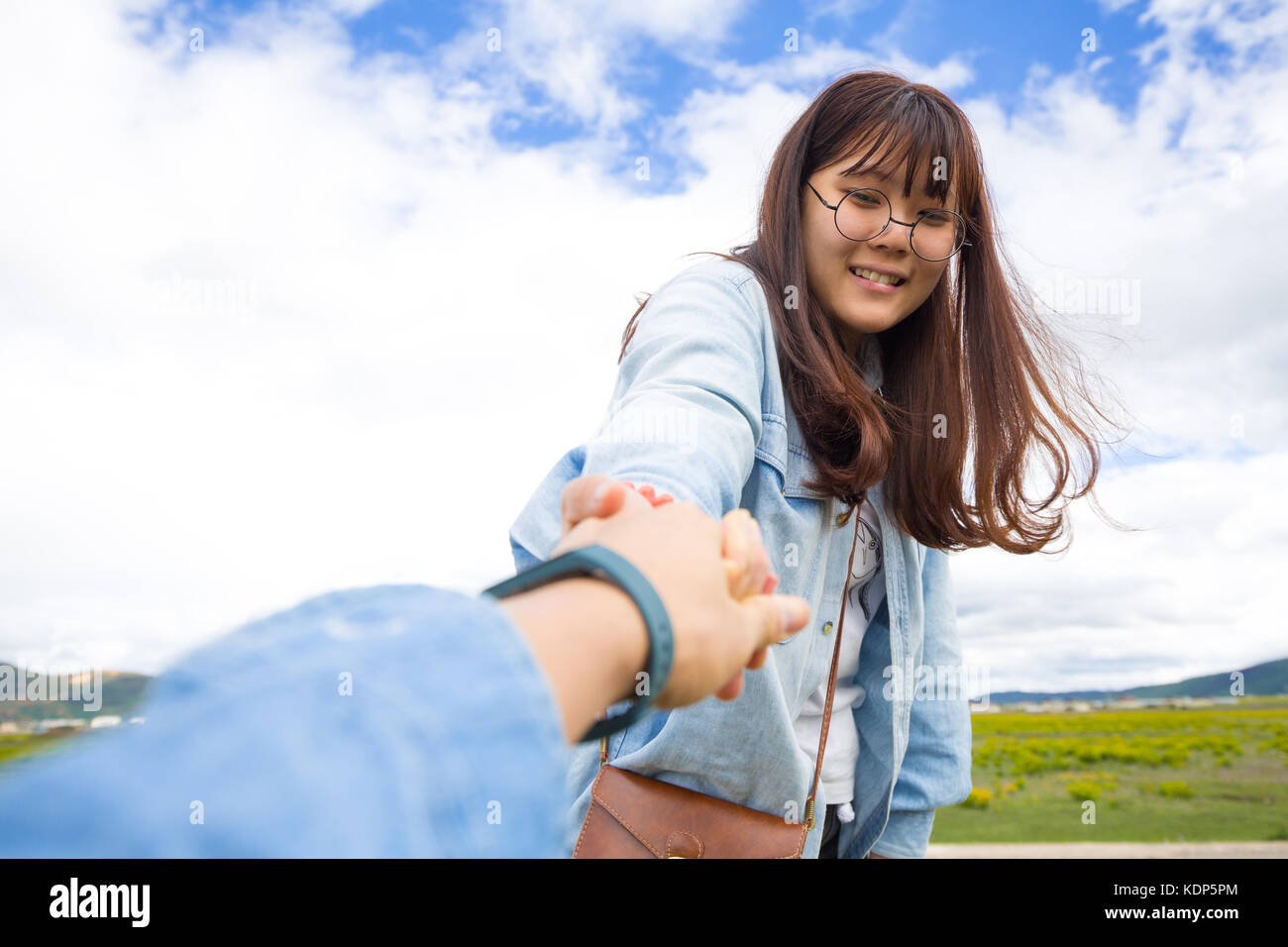 Asian girl pulling hand Stock Photo Alamy