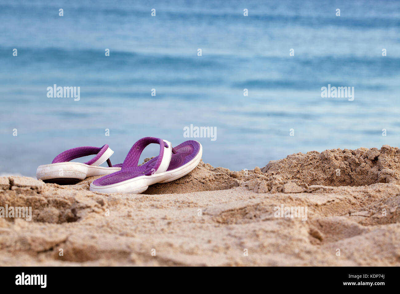 Ocean Beach with Sandals on a sunny summer day Stock Photo