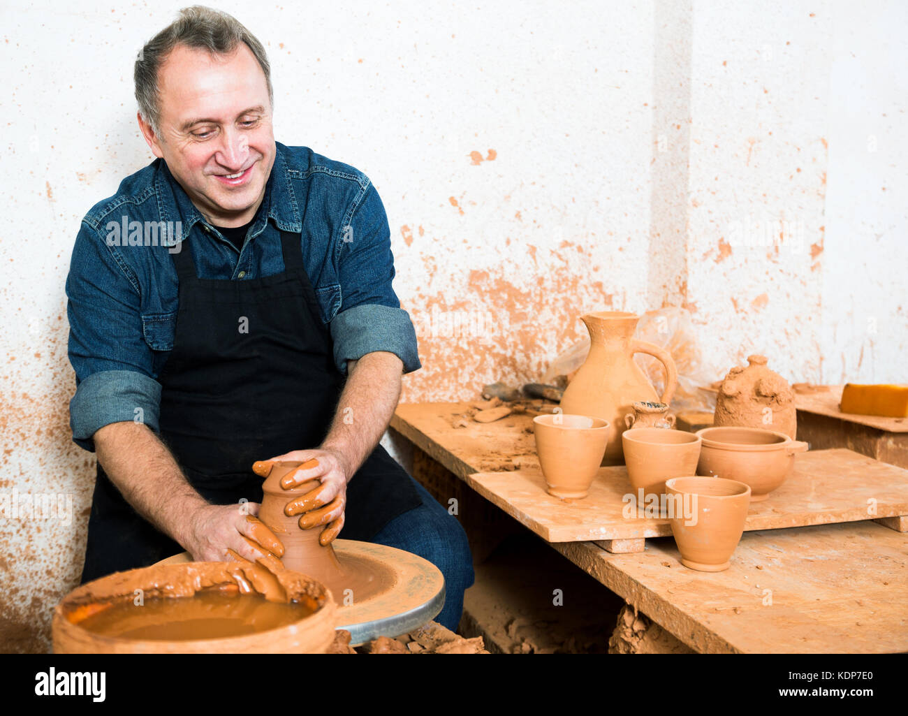 Male master among the pottery at the workshop Stock Photo - Alamy
