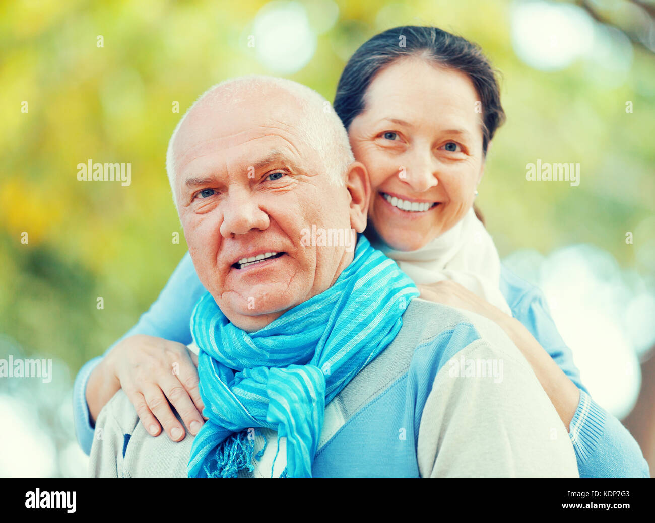 Portrait of smiling senior couple in sweaters at autumn park Stock ...