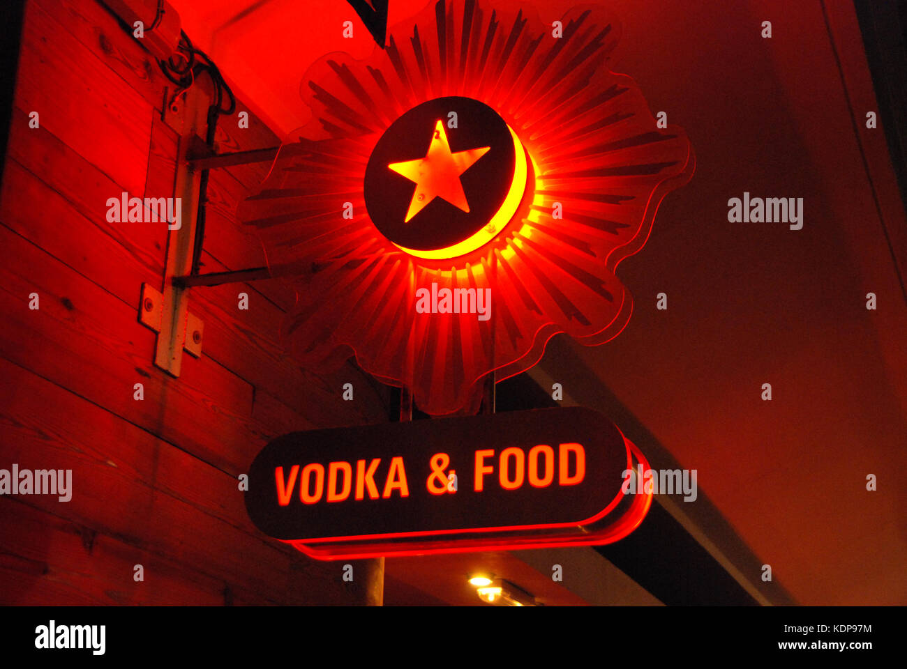 2000, close-up picture of a red, orange and yellow neon sign at night with a red star logo and the words 'Vodka & Food' in capital letters below it, London, England.  Both the red star and vodka are symbolic of the communist country Russia. Stock Photo