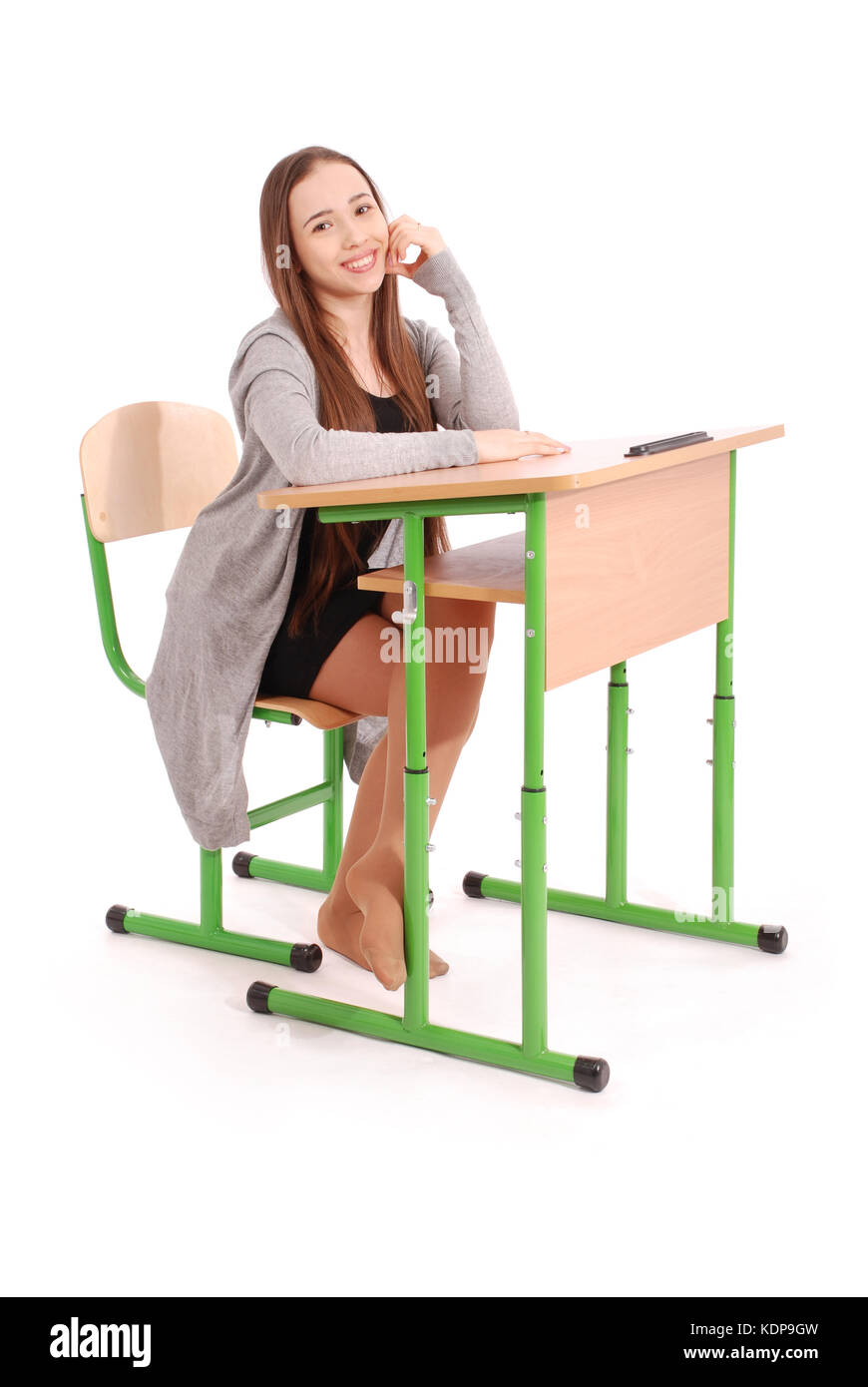 School girl sitting at a desk isolated on white Stock Photo - Alamy