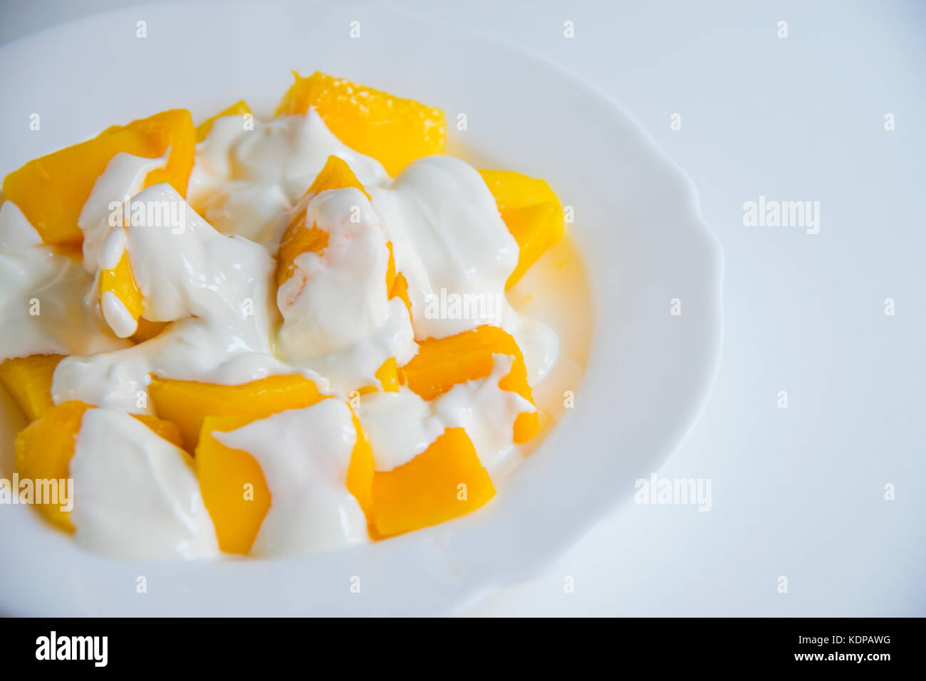 Mango with cream Stock Photo Alamy