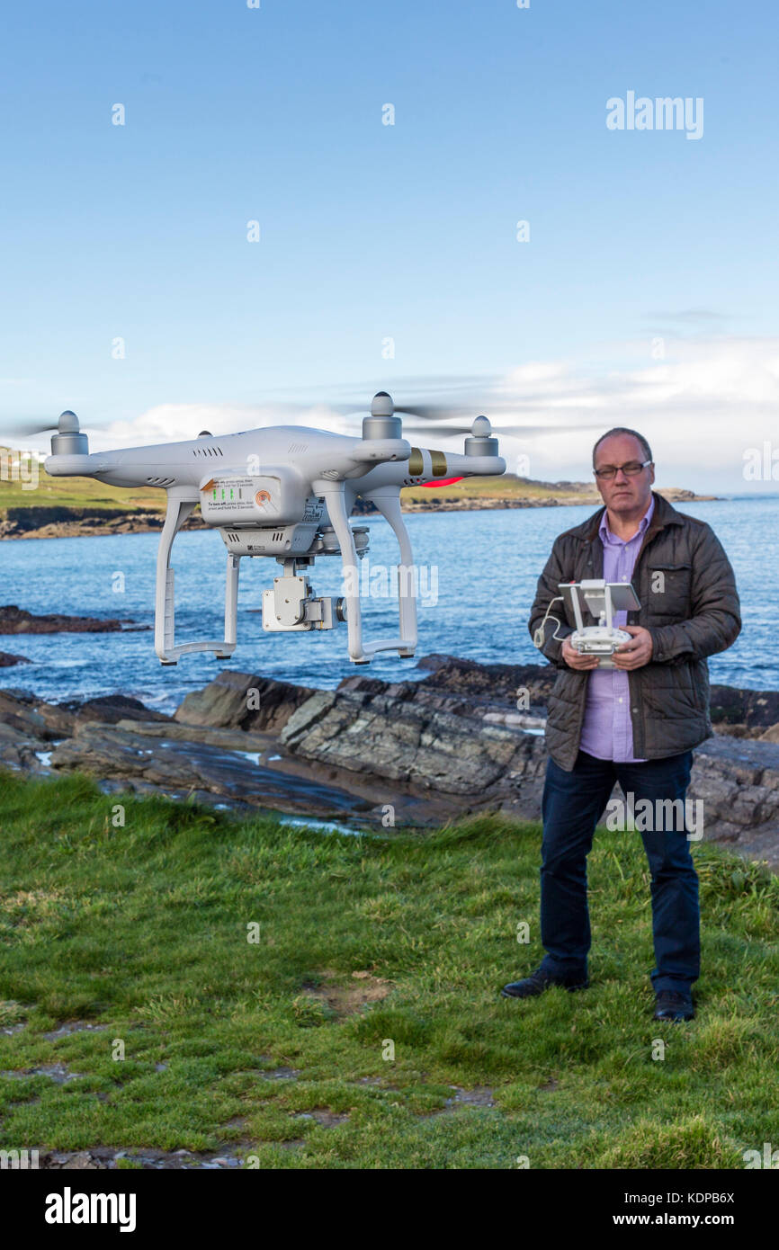 Middle age man, photographer flying a drone, County Kerry Ireland Stock Photo