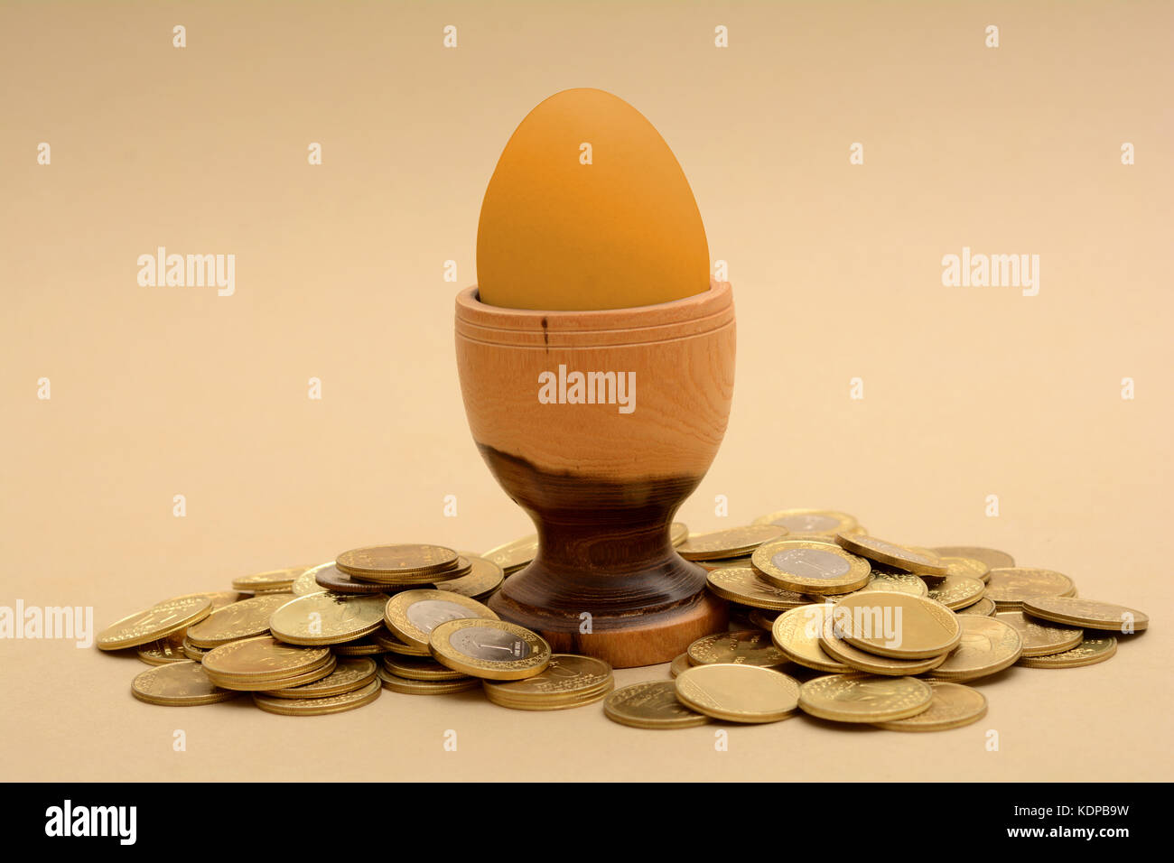 Golden Egg concept with gold coins pile. Stock Photo