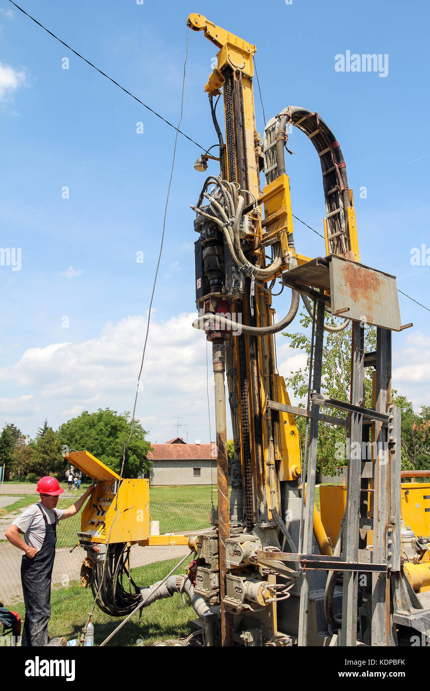 Drilling geothermal well for a residential geothermal heat pump. Stock Photo