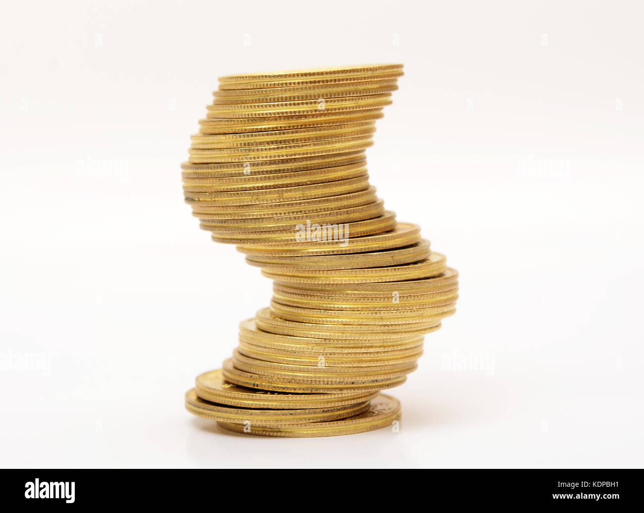 Unstable stack of gold coins Risk Concept. Stock Photo
